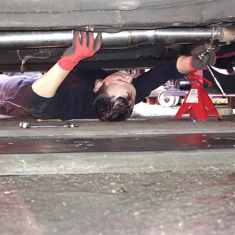 working on modifications underneath a dsm car