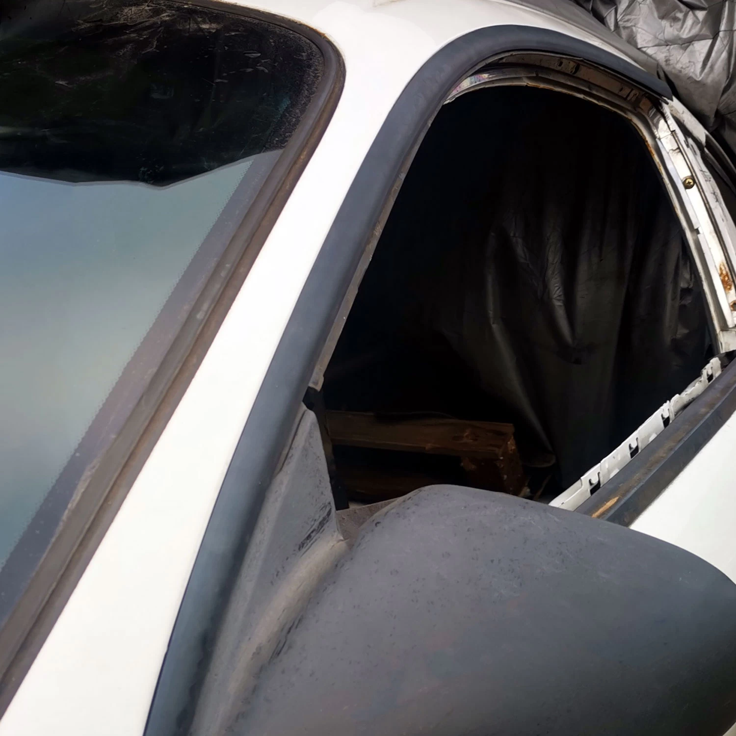 close up of 2G DSM Mitsubishi black drip rail replacement molding DIY kit on a white DSM chassis